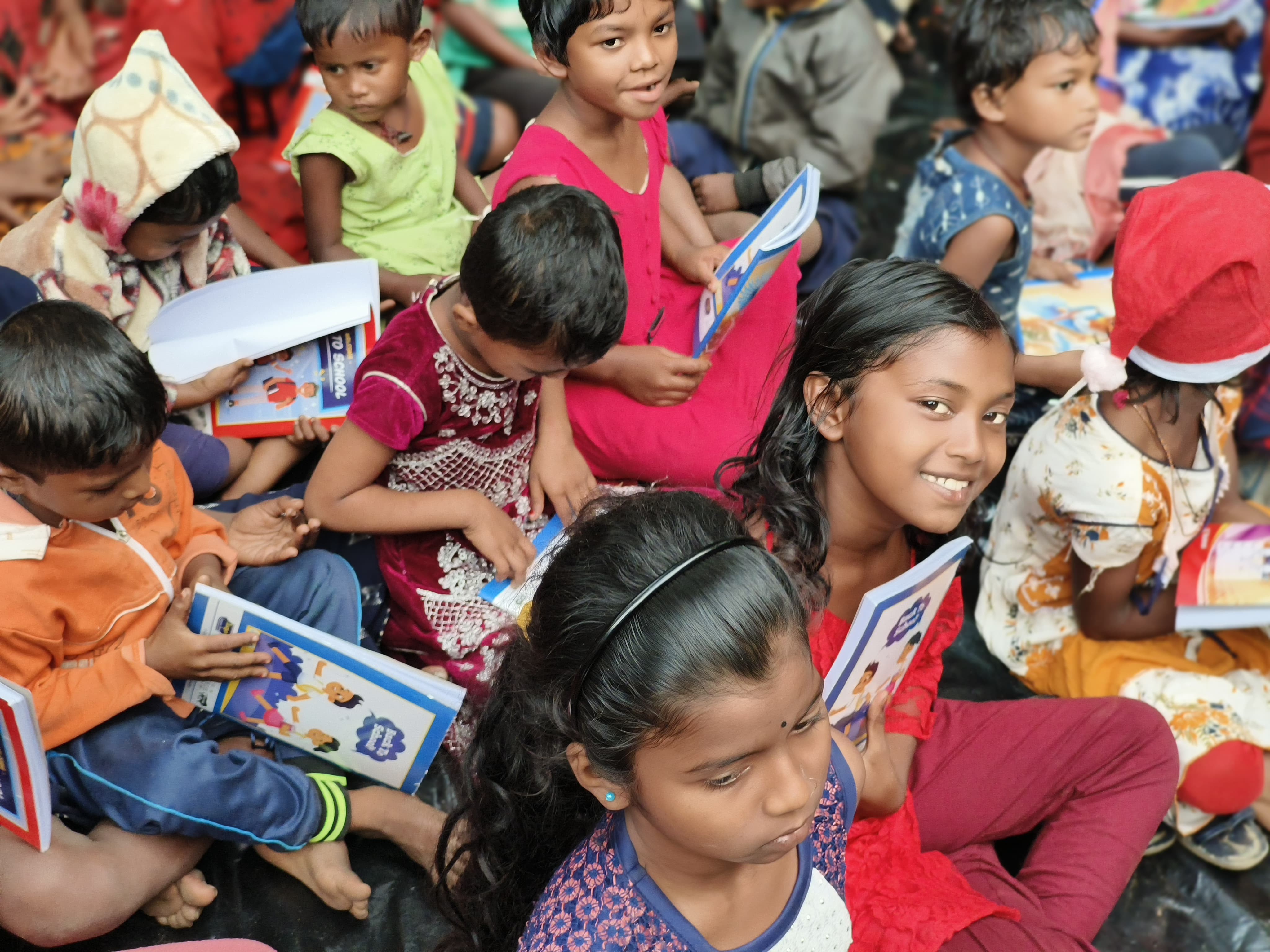 Smiling children reading books together